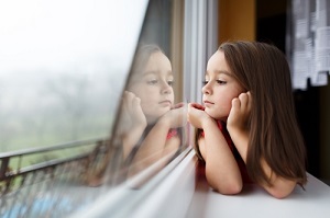 little girl looking out of a window